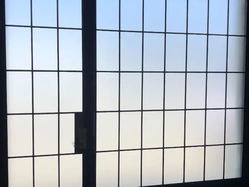 Backlit frosted glazing in a steel grid frame, private from both sides.