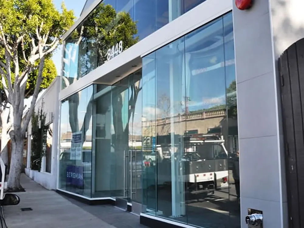 Storefront entry glazing filmed for impact resistance, still fully clear.
