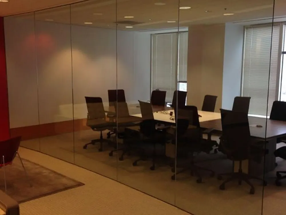 Interior office glazing before any privacy film — the whole room visible from the corridor.