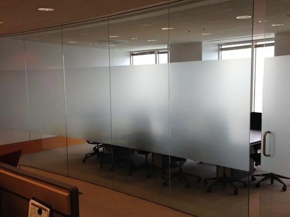 A boardroom given privacy with frosted film instead of blinds or solid walls.